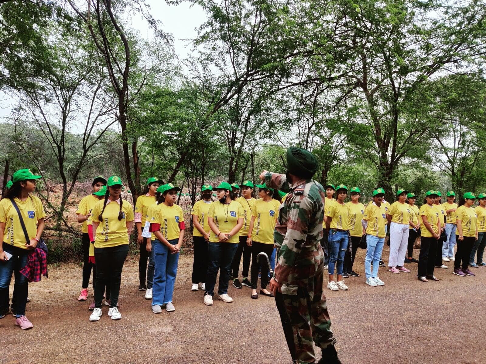 Sewa International volunteers planting saplings during a community plantation drive